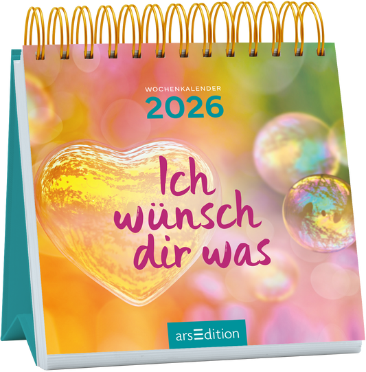 Der Kalender zeigt ein sanftes, farbenfrohes Hintergrundbild mit pastellfarbenen Blasen und einem warmen, herzförmigen Element in der Mitte. In verspielter, lila Schrift steht „Ich wünsch dir was“ prominente platziert. An der Oberseite ist „WOCHENKALENDER 2026“ in einem helleren Blauton zu sehen. Die Gesamtatmosphäre ist freundlich und einladend. Ganz unten mittig steht der Logoschriftzug von arsEdition.