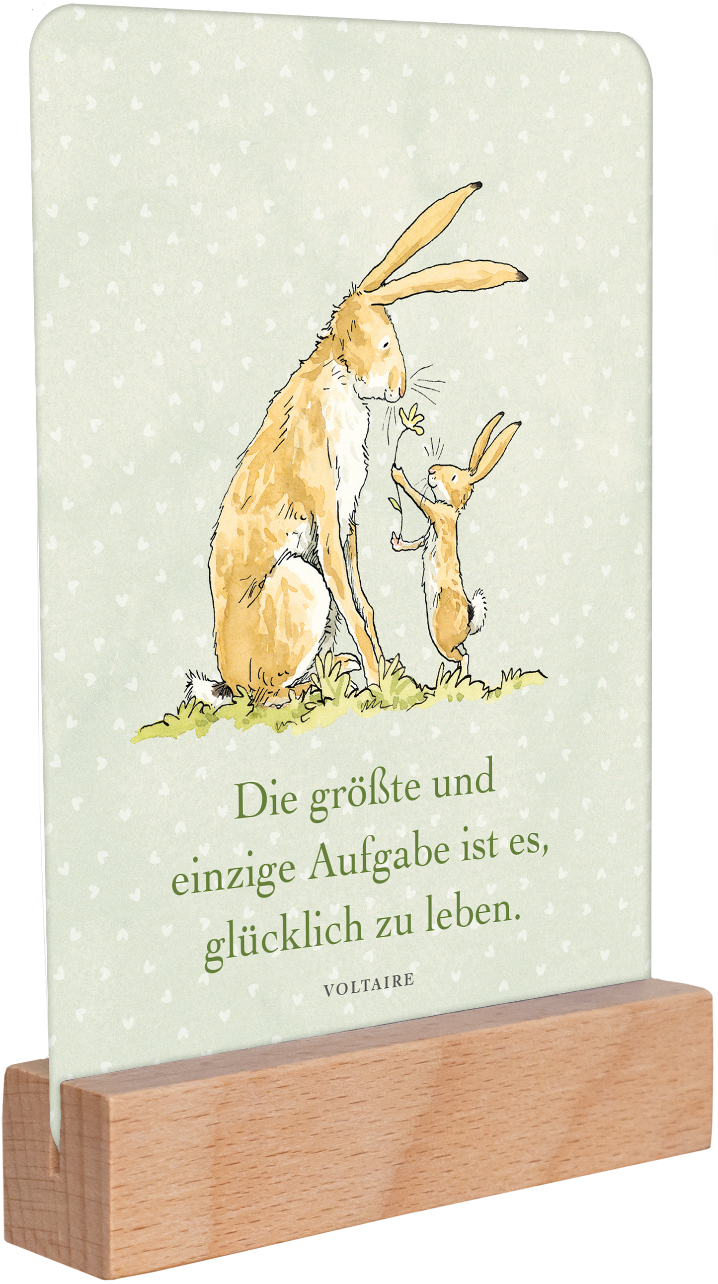 Gezeigt wird eine Innen- oder Zusatzansicht von „Weißt du eigentlich, wie lieb ich dich hab? Geburtstagskalender im Holzständer“. Die Ansicht zeigt eine sanft grüne Hintergrundfarbe mit kleinen, weißen Punkten. Darauf sind zwei niedliche Hasen illustriert, der größere Hase steht neben einem kleineren und hält ein Blatt. In der Mitte befindet sich der Schriftzug: „Die größte und einzige Aufgabe ist es, glücklich zu leben“ in klarer, schwarzer Schrift. Der Holzständer gibt dem...