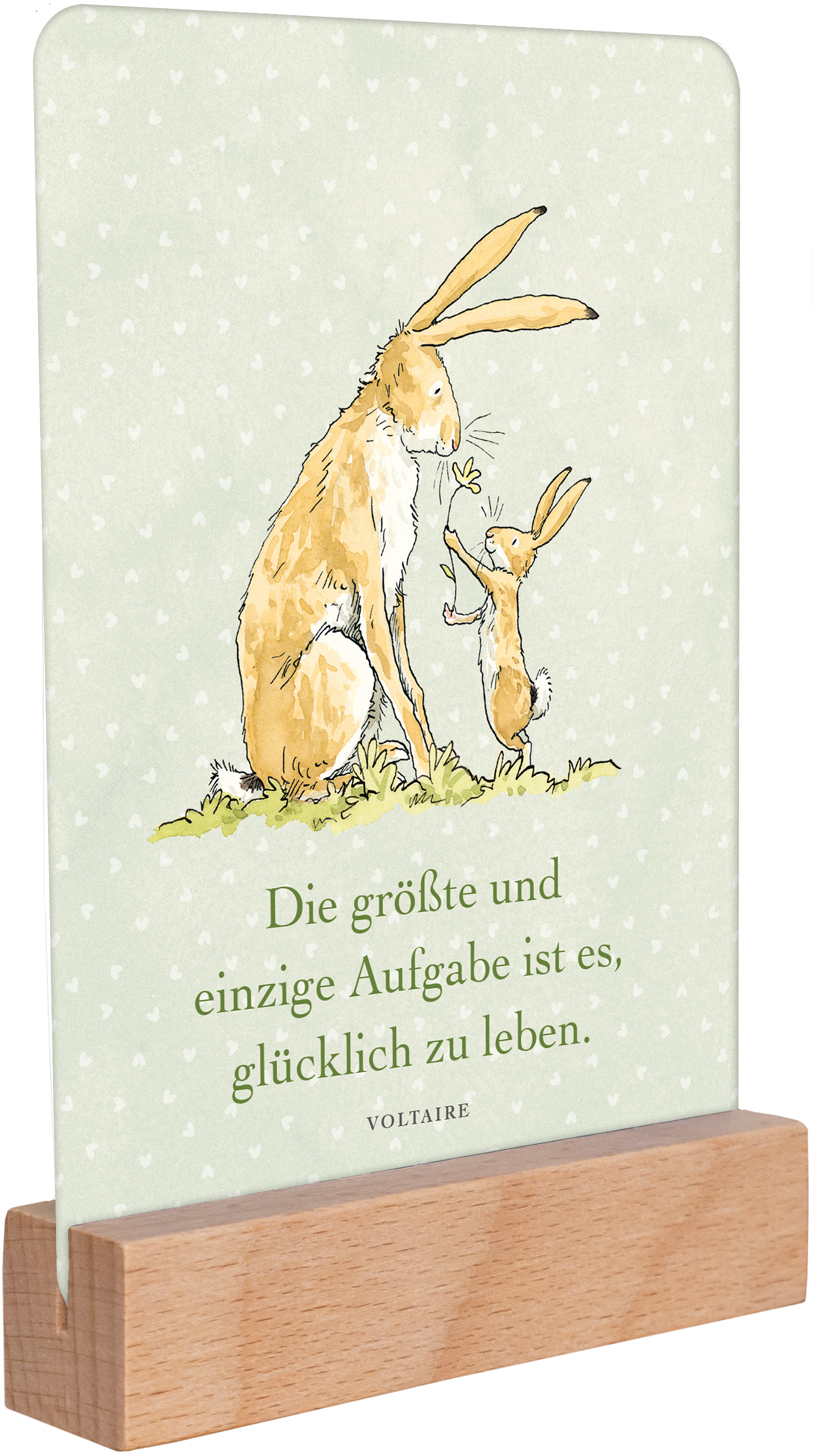 Gezeigt wird eine Innen- oder Zusatzansicht von „Weißt du eigentlich, wie lieb ich dich hab? Geburtstagskalender im Holzständer“. Die Ansicht zeigt eine sanft grüne Hintergrundfarbe mit kleinen, weißen Punkten. Darauf sind zwei niedliche Hasen illustriert, der größere Hase steht neben einem kleineren und hält ein Blatt. In der Mitte befindet sich der Schriftzug: „Die größte und einzige Aufgabe ist es, glücklich zu leben“ in klarer, schwarzer Schrift. Der Holzständer gibt dem...