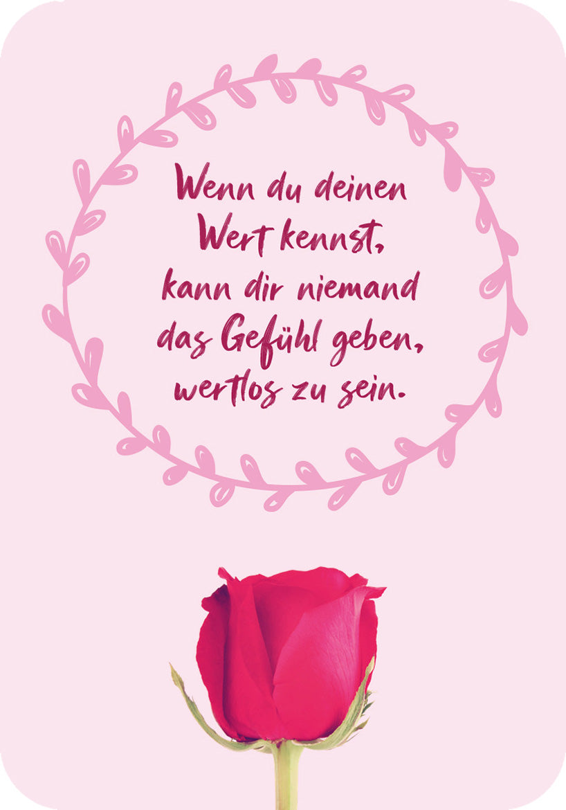 Gezeigt wird eine Innen- oder Zusatzansicht von „Für eine tolle Frau wie dich“. Im Bild ist ein sanfter, rosa Hintergrund zu sehen, umrahmt von einem filigranen, kreisförmigen Blätter-Design in einem helleren Rosa. In der Mitte steht der motivierende Text: „Wenn du deinen Wert kennst, kann dir niemand das Gefühl geben, wertlos zu sein.“ Dieser ist in einer ansprechenden, handschriftlichen Typografie in Dunkelrot gehalten. Unten im Bild befindet sich eine detailreiche, rote Rose.