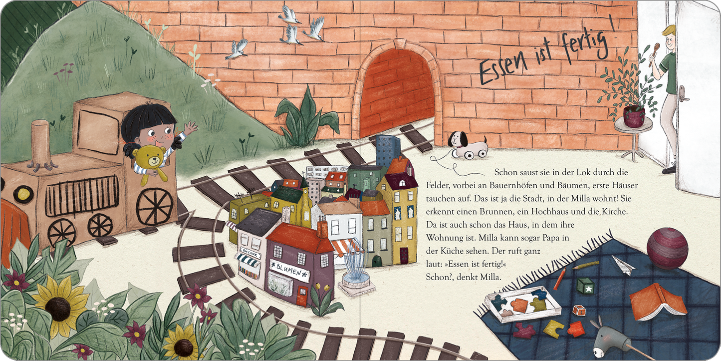 Gezeigt wird eine Innen- oder Zusatzansicht von „Der Wunderkarton“. Die Illustration zeigt eine bunte, freundliche Szenerie mit einer kleinen Lok und einem Mädchen, das einen Teddybären hält. Im Hintergrund sind gelbe Sonnenblumen und grüne Wiesen zu sehen. Farbig gestaltete Häuser mit roten und blauen Dächern bilden eine kleine Stadt. Am oberen Rand steht in verspielter Schrift „Essen ist fertig“. Die sanften Farben und die kindgerechte Typografie laden zum Träumen und Entdecken...