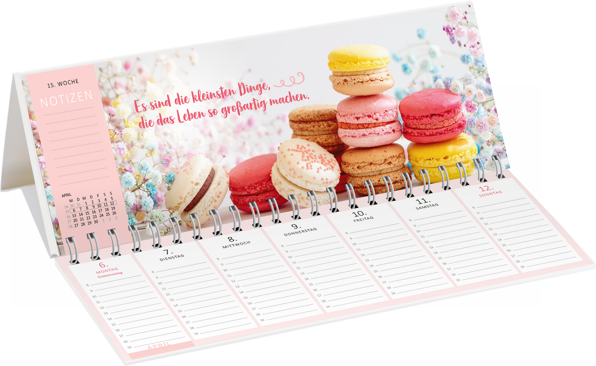 Gezeigt wird eine Innen- oder Zusatzansicht von „Tischkalender Glücksmomente 2026“. Der Kalender präsentiert eine ansprechende Illustration von bunten Makarons auf einem blütenhaften Hintergrund. Oben links befindet sich ein Bereich für Notizen, im sanften Rosaton, mit klaren, gut lesbaren Zahlen und Monatsangaben. Die zentrale Aussage „Es sind die kleinsten Dinge, die das Leben so großartig machen“ ist in einer verspielten, handgeschriebenen Schriftart in einem warmen Rotton...