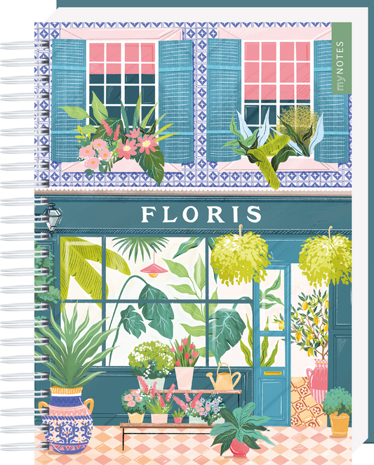 Das Buchcover zeigt eine farbenfrohe, dekorierte Geschäftsfassade mit dem Schriftzug „FLORIS“ in elegantem Weiß. Über den Fenstern sind blaue Fensterläden und üppige Blumenarrangements zu sehen. Große Pflanzen in verschiedenen Grüntönen charakterisieren den Eingangsbereich, während der Boden mit bunten Fliesen gestaltet ist. Die Atmosphäre ist lebhaft und einladend. Ganz unten mittig steht der Logoschriftzug von arsEdition.