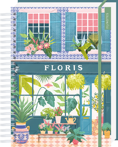 Das Buchcover zeigt eine charmante, blühende Fensterfront eines Ladens mit der Aufschrift „FLORIS“ in großen, weißen Buchstaben. Die Fassade ist in sanften Blau- und Rosatönen gehalten, während üppige Pflanzen und Blumen vor einem hellen Hintergrund florieren. Der stilvolle, detailreiche Druck strahlt ein Gefühl von Frische und Lebensfreude aus. Ganz oben mittig steht der Logoschriftzug von arsEdition.