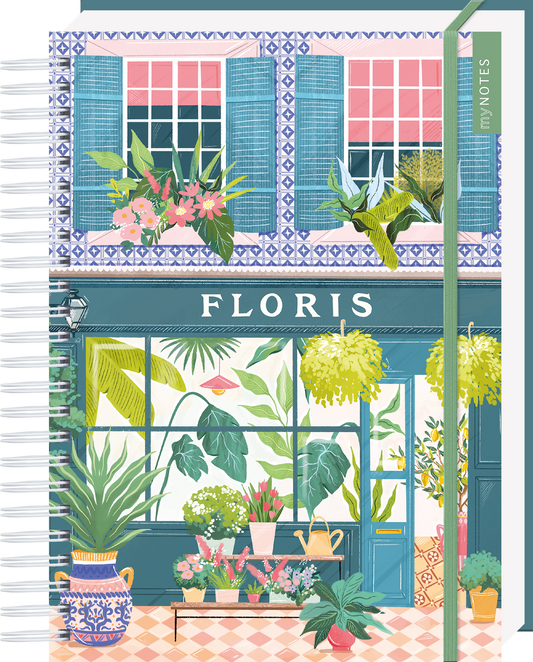 Das Buchcover zeigt eine charmante, blühende Fensterfront eines Ladens mit der Aufschrift „FLORIS“ in großen, weißen Buchstaben. Die Fassade ist in sanften Blau- und Rosatönen gehalten, während üppige Pflanzen und Blumen vor einem hellen Hintergrund florieren. Der stilvolle, detailreiche Druck strahlt ein Gefühl von Frische und Lebensfreude aus. Ganz oben mittig steht der Logoschriftzug von arsEdition.
