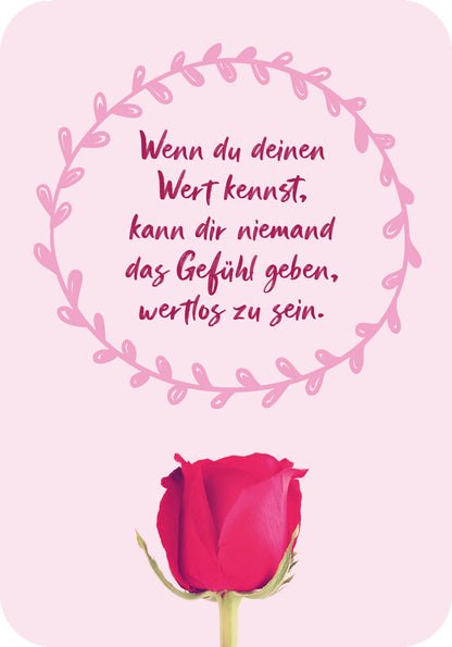 Gezeigt wird eine Innen- oder Zusatzansicht von „Für eine tolle Frau wie dich“. Im Bild ist ein sanfter, rosa Hintergrund zu sehen, umrahmt von einem filigranen, kreisförmigen Blätter-Design in einem helleren Rosa. In der Mitte steht der motivierende Text: „Wenn du deinen Wert kennst, kann dir niemand das Gefühl geben, wertlos zu sein.“ Dieser ist in einer ansprechenden, handschriftlichen Typografie in Dunkelrot gehalten. Unten im Bild befindet sich eine detailreiche, rote Rose.