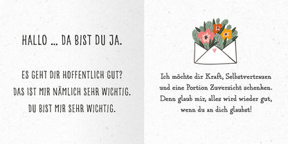 Gezeigt wird eine Innen- oder Zusatzansicht von „Das kleine Alles-wird-gut-Buch“. Die linke Seite enthält in größerer Schrift die Begrüßung „HALLO … DA BIST DU JA.“ sowie die Fragen „ES GEHT DIR HOFFENTLICH GUT?“ und „DU BIST MIR SEHR WICHTIG“ in einer verspielten Schriftart. Die rechte Seite zeigt eine liebevoll illustrierte Umschlag mit bunten Blumen und Text in einer klaren, gut lesbaren Schrift: „Ich möchte dir Kraft, Selbstvertrauen und eine Portion Zuversicht...