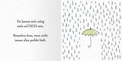 Gezeigt wird eine Innen- oder Zusatzansicht von „Das kleine Alles-wird-gut-Buch“. Auf der linken Seite steht der motivierende Text in klarer, gut lesbarer Typografie in Schwarz. Die rechte Seite zeigt eine sanfte, hellgrüne Regenbogen-Regenschirm-Illustration, umgeben von stilisierten blauen Regentropfen auf weißem Hintergrund. Der Gesamteindruck ist freundlich und aufmunternd, mit harmonischen Farben, die den positiven Inhalt unterstützen.