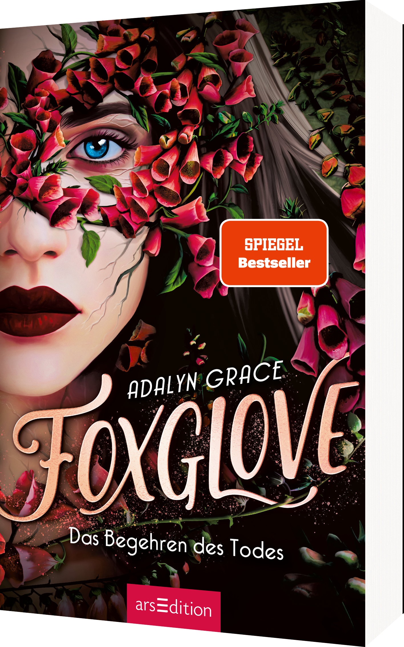 Das Buchcover zeigt das Gesicht einer Frau mit intensiven blauen Augen und einem geheimnisvollen, leicht melancholischen Ausdruck. Ihr Gesicht ist teilweise von einer dichten Blütenpracht in verschiedenen Rot- und Grüntönen umgeben. Der Titel „Foxglove“ ist in geschwungener, eleganter Schrift in beige gehalten, während der Untertitel „Das Begehren des Todes“ in einer sanften, leichteren Schrift darunter steht. Oben rechts befindet sich ein „SPIEGEL Bestseller“-Button. Ganz unten...