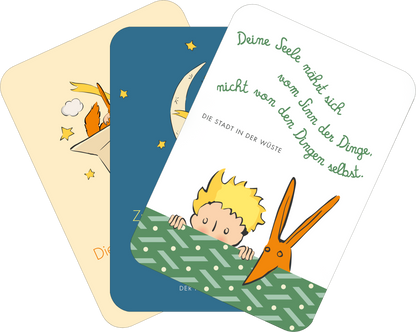 Gezeigt wird eine Innen- oder Zusatzansicht von „Der Kleine Prinz. 50 Glückskärtchen für jeden Tag“. Die Karten sind in sanften Farben gehalten – beige, blau und grün. Illustrationen zeigen den kleinen Prinzen, Sterne und eine Schere. Die Typografie ist verspielt und handschriftlich, wobei wichtige Textteile in eleganten Schriftarten hervorgehoben sind. Jede Karte vermittelt positive Botschaften und inspiriert zur Reflexion.
