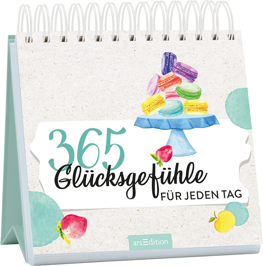 Auf dem Buchcover steht der Titel „365 Glücksgefühle“ in großen, lebendigen Farben, begleitet von der Unterzeile „FÜR JEDEN TAG“ in einer eleganten Schriftart. Ein blauer Kuchenstand präsentiert farbenfrohe Macarons und Früchte, die eine fröhliche und einladende Atmosphäre schaffen. Der Hintergrund ist in sanften, neutralen Tönen gehalten. Ganz unten mittig steht der Logoschriftzug von arsEdition.