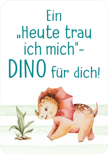 Gezeigt wird eine Innen- oder Zusatzansicht von „Mutmachkarten – Dino (Aquarelloptik)“. Die Karte zeigt einen niedlichen, aquarellierten Dino in sanften Farbtönen, hauptsächlich in Rosa und Gelb. Der Dino steht auf einer grünen Fläche, flankiert von stilisierten Pflanzen. Der Text in klarer, dunkeltürkisfarbener Schrift lautet: „Ein ‚Heute traue ich mich‘-DINO für dich!“ und hebt sich gut vom Hintergrund ab, was die Lesbarkeit unterstützt.